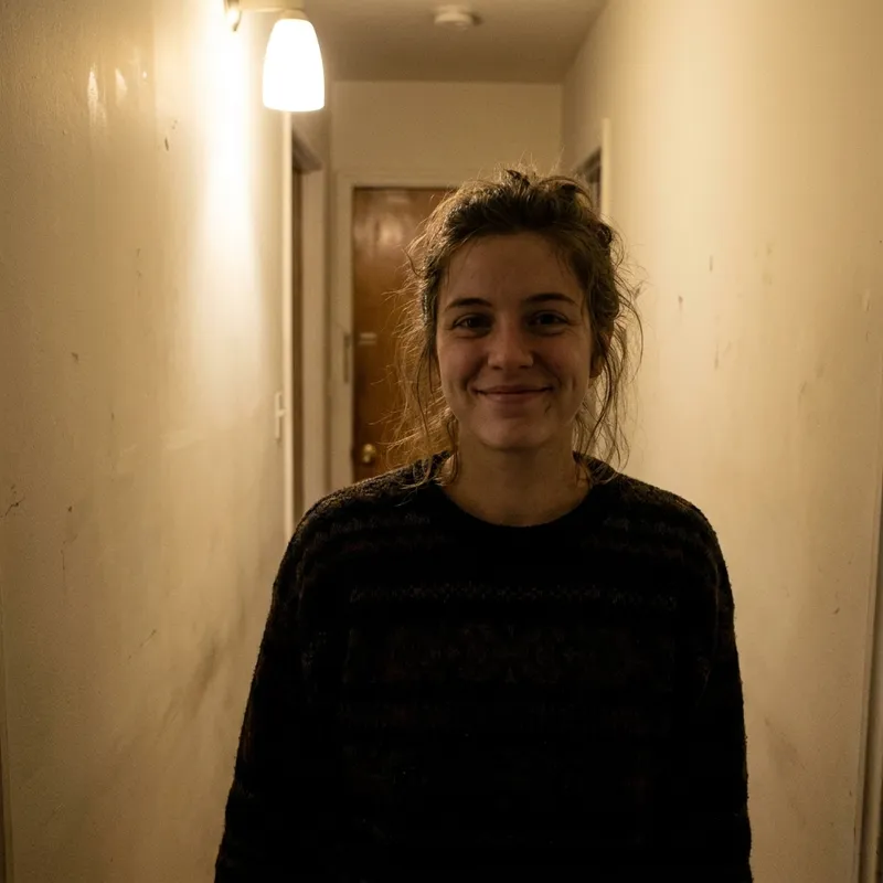 Original photo of a woman photographed in a dim apartment hallway